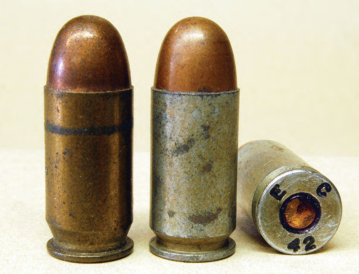 The Evansville plant was set up to make brass-cased .45 ACP (left), but was then ordered to figure out how to make steel cases (center). Headstamps of both are E C 42.